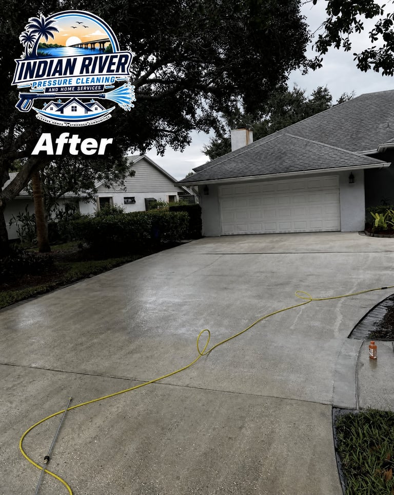 Clean residential driveway with single-car garage after pressure washing by Indian River Pressure Washing, shown in portfolio as After result
