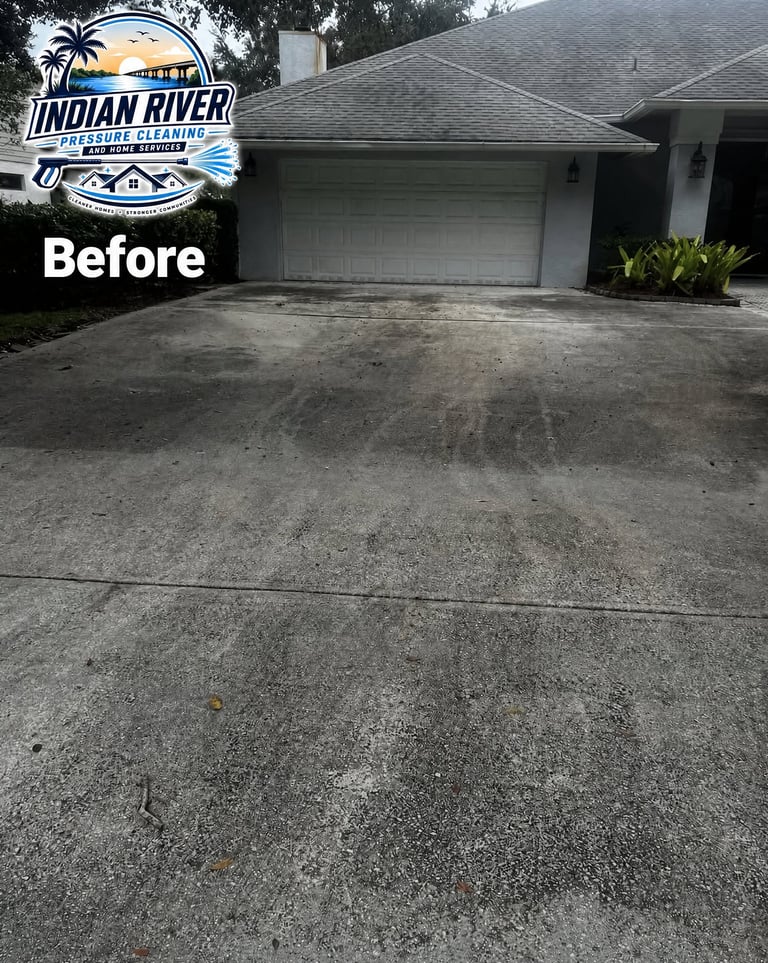 Dirty concrete driveway before pressure washing, with Indian River Pressure Washing logo in corner